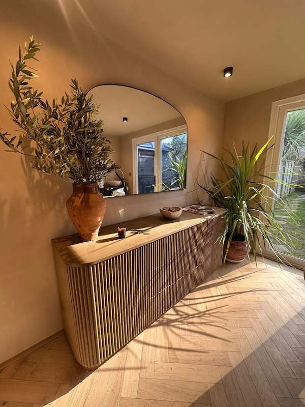 Bespoke fluted oak console with arched mirror and herringbone floor